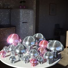 shiny disco balls on a table in front of a refrigerator