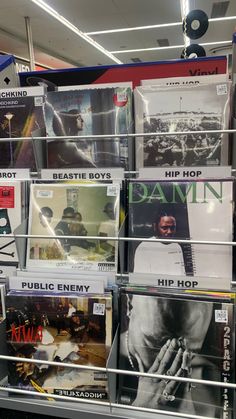 a rack full of various records on display in a store or office area with metal bars