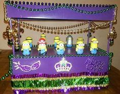 a purple cake with minion figures on it