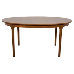 an oval wooden table with two leaves on the top and one leaf at the bottom