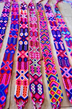 colorful bracelets are laid out on the ground