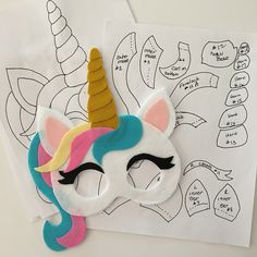 a paper cut out of a unicorn's face and the outline for its mask