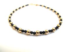 Luxurious bracelet handmade solid 14 k yellow gold beads and black onyx beads  UNISEX   Threaded on 24 k gold plated stainless steel wire   14 K solid yellow Gold beads solid gold not plated 3 mm  Genuine non synthetic 2 mm black onyx beads  14 k solid gold end caps  14 k solid spring closure * Casual  * By Symbolina Bracelet comes in an elegant box Thanks for visiting symbolina store Have a lucky day Item: SY 1220 To share with your friends pin it on Pinterest. Click Like to show them on Facebo Adjustable Gold Onyx Bracelet, Adjustable Gold Onyx Bracelets, Luxury Gold Jewelry With Black Beads, Black Round Gold Bracelet As Gift, Black Gold Round Bracelet As Gift, Elegant Yellow Gold Bracelets With Black Beads, Elegant Yellow Gold Bracelet With Black Beads, Adjustable Gold Bracelet With Polished Beads, Gold Beaded Bracelets With Onyx Gemstones