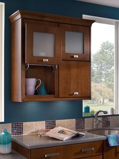 a kitchen with blue walls and wooden cabinets