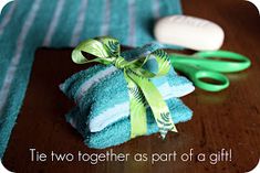 two blue towels and green scissors on a table with the words tie together as part of a gift