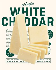 white cheddar cheese is stacked on top of each other in front of an advertisement