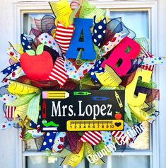 a colorful door wreath with the word mrs lopez written in large letters on it