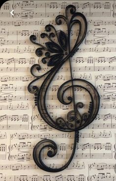 a metal music note sitting on top of sheet music