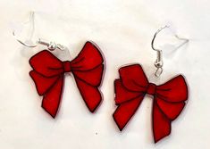 pair of red bow earrings on white background