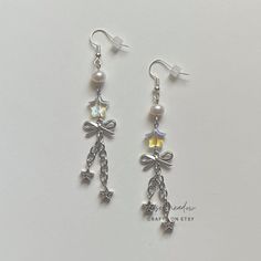 "Handmade Beaded Earrings ✿ Made with glass beads, freshwater pearls, and metal accents ✿ Silver, iridescent clear, and pearlescent white ✿ The earrings are 3.1\"  Fish Hook Options ✿ The Titanium fish hook is hypoallergenic and ideal for sensitive skin ✿ The regular fish hook is made of nickel free metal, it is not hypoallergenic" Handmade Silver Pearl Beaded Earrings, White Metal Dangle Crystal Earrings, Silver Pearl Beaded Drop Earrings, Silver Pearl Beaded Earrings For Party, Silver Pearl Earrings With Dangling Beads As Gift, Diy Earrings Dangle, Kpop Earrings, Ethereal Jewelry, Diy Beaded Rings