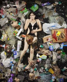 a woman in a bathing suit surrounded by trash