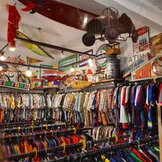 there are many different items on display in this store, including shirts and umbrellas