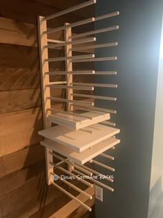 the shelves are made out of wood and have metal bars attached to each one side