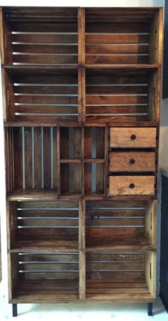 an old wooden bookcase with drawers on it