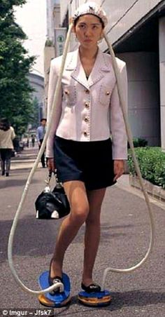 a woman is walking down the street with a hose attached to her head and shoes on