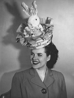 a woman wearing a hat with stuffed animals on it