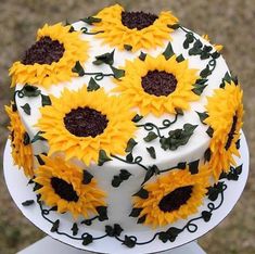 a decorated cake with sunflowers on it