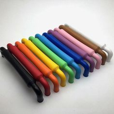 several different colored pens lined up in a row