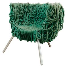 a green chair that is sitting on some metal legs