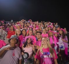 a large group of people in pink shirts