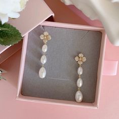 * DETAILS * - High Quality CZ Paved Flower Ear Post Gold Plated Brass Earrings  - Freshwater Long Oval Shaped Pearls  👉🏻For more earrings, see https://www.etsy.com/shop/JinnysJewelryBySeJin 🎁 These earrings come in a special designer pouch enclosed in a cardboard box. A designer pull drawer pink gift box is available when the gift wrapping option is chosen. 👉🏻Please note that all Jinny's Jewelry pieces are crafted by hand and one-of-a-kind, and may therefore vary slightly in size and shape. Elegant Dangle Flower Earrings For Bridesmaids, Wedding Pearl Earrings With Flower Shape, Flower Decorated Drop Bridal Earrings, Elegant Flower Shaped Earrings For Bridesmaids, Elegant Flower Earrings For Bridesmaids, Bridal Drop Earrings With Flower Decoration, Elegant Flower Bridal Earrings For Bridesmaids, Elegant Wedding Jewelry With Flower Decoration, Flower Shaped Pearl Drop Earrings For Wedding