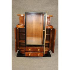 an art deco display cabinet with two doors and drawers