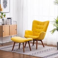 a yellow chair and footstool in front of a window