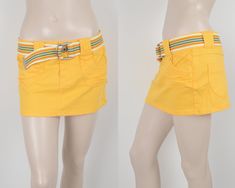 Vintage Y2K 2000s X-Mail very short mini yellow skirt. Denim jeans fabric skirt. 2 front skirt. 2 back skirt. With colorful belt (removable). Front zipper button closure. Medium stretchy fabric. Size Small/Medium. NOTE that this skirt is very SHORT  ✰✰ GARMENT DETAILS: ~ Brand: X-Mail  ~ Made in: --- ~ Fashion era: 2000s ~ Fabric: 98 % Cotton , 2 % Elastane ~ Color: yellow ~ Condition: very good vintage condition ~ Vintage tag size: 36/38 ~ Estimated (fits) size: Small / Medium *see measurements to see how it will fit you. ✰✰ 📏MEASUREMENTS: Measurements - taken from seam to seam while the garment is lying flat. ~ Waist (perimeter): 80 cm / 31.5 inch ~ Hips (perimeter): 94 cm / 37 inch ~ Length: 28 cm / 11 inch *measurements are approximate. *to see if a garment will fit you, take a simila Y2k Style Yellow Summer Bottoms, Cotton Mini Skirt In Y2k Style, Y2k Style Cotton Stretch Skirt, Y2k Style Stretch Cotton Skirt, Fitted Mini Denim Skirt, Y2k Mini Skort For Spring, Y2k Style Stretch Cotton Skort, 90s Style Mini Skort For Summer, Y2k Style Mini Skort For Summer