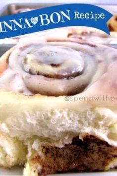 a cinnamon roll with icing sitting on top of a white plate