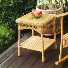 a small wicker table with two apples on it