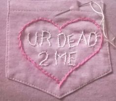 a pink heart with the words our dead 2 me written on it in white thread