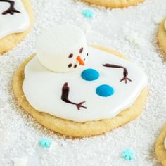 decorated cookies with frosting and icing are arranged in the shape of a snowman