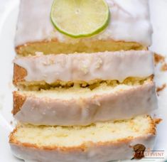 a loaf of lemon pound cake with frosting and a lime slice