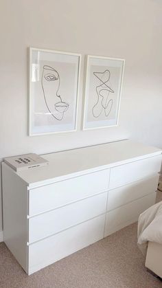 two framed pictures above a white dresser in a bedroom