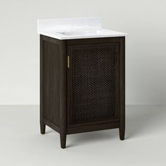 a bathroom vanity with a white sink and dark wood finish on the top, against a gray background