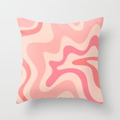 a pink and white pillow with wavy lines