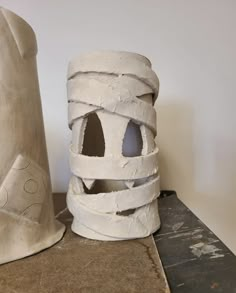 two clay sculptures sitting next to each other