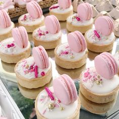 many pink and white desserts are on display