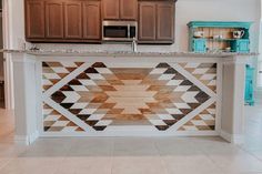 a kitchen island made out of wood and white marble counter top with an abstract design on it