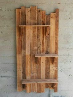 a wooden shelf made out of pallets on the wall