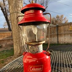 a red lantern sitting on top of a metal table