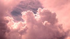 the sky is filled with pink clouds as it looks like they are floating in the air