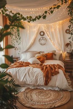 a bed with white linens and lights on the headboard is surrounded by greenery