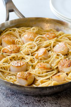 scallops and noodles in a skillet on a table