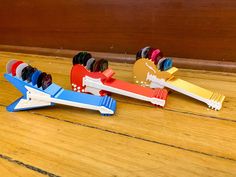 three toy airplanes sitting on top of a wooden floor