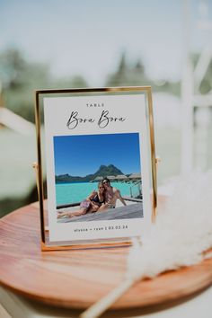 a table with a card and feather on it