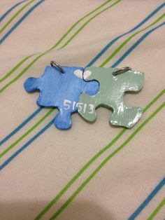 two pieces of puzzle sitting on top of a bed