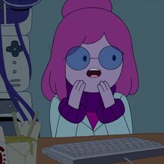 a cartoon character sitting in front of a computer keyboard and monitor with her hands on her face