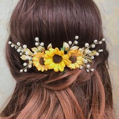 a woman wearing a sunflower and pearl hair comb