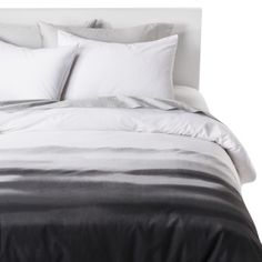 a black and white bed with two pillows